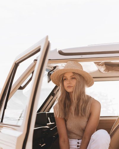 White Female Model Sitting in Ute Wearing The Will & Bear River Sand Hat